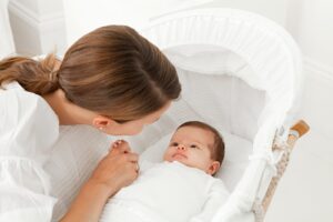 Mother with baby in bassinet